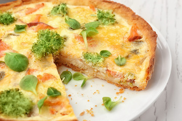 Tasty salmon quiche on plate, closeup