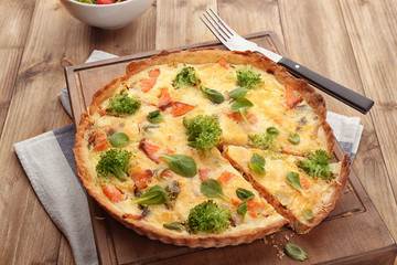 Tasty salmon quiche on wooden board