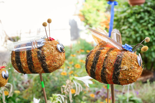 Funny straw bees used as garden decor outdoors