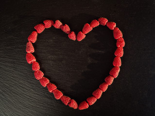 Obraz premium raspberry in the form of heart,growing raspberries,raspberries background closeup photo,high resolution product,Delicious first class organic fruit,Raspberry as background