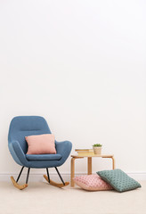 Interior of beautiful room with rocking chair and light carpet