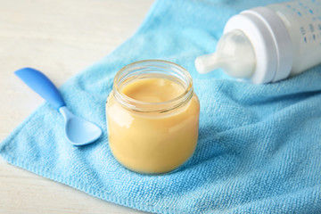 Jar of tasty baby food on table