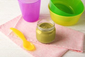 Jar of tasty baby food on table