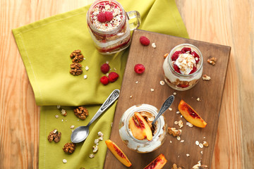 Healthy breakfast with oatmeal and yogurt in jars on table