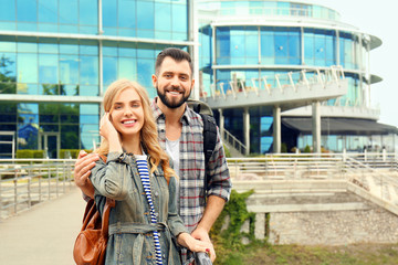 Happy young tourists in beautiful city