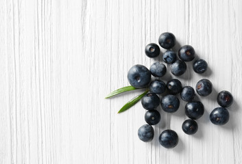 Fresh acai berries on wooden background © Africa Studio