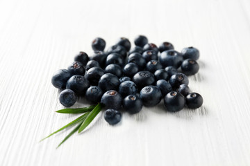 Fresh acai berries on wooden table, closeup