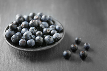 Plate with fresh acai berries on table, closeup