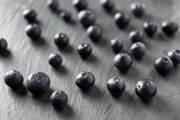 Fresh acai berries on dark background, closeup