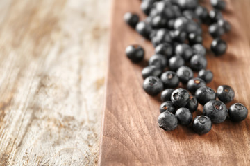 Fresh acai berries on wooden table, closeup
