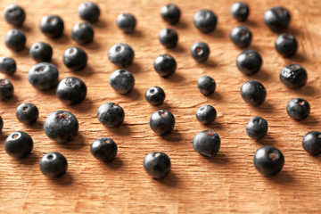 Fresh acai berries on wooden table, closeup