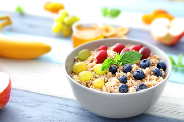 Nutritious oatmeal with berries on table