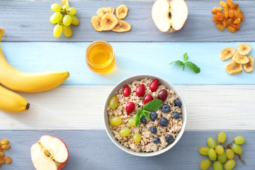 Nutritious oatmeal with berries on table