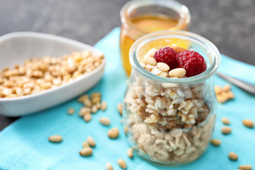 Jar with tasty oatmeal on table