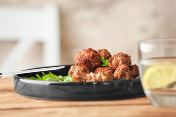 Plate with tasty sausage cheese balls on table