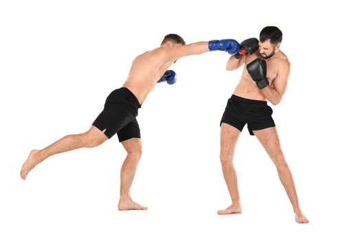 Male kickboxers fighting on white background © Africa Studio