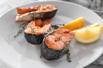 Grilled salmon steaks on plate, close up
