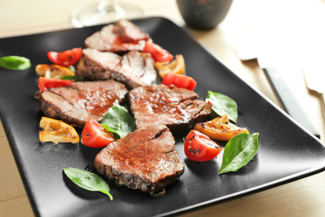 Sliced delicious steak on plate, close up
