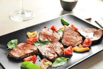 Sliced delicious steak on plate, close up