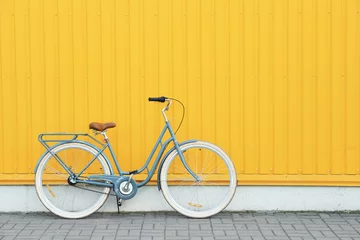 Fotobehang Retro bicycle near yellow wall outdoors © Africa Studio