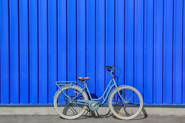 Retro bicycle near blue wall outdoors