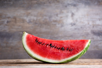 Slice of ripe watermelon on wooden background