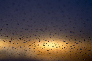 raindrops on car windshield sunset
