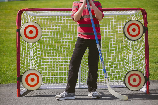 Portrait of Boy Playing Street Hockey