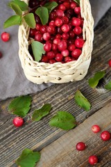 Fresh red cranberries with leaves on the table 