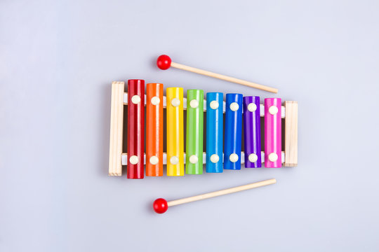 Colorful xylophone and sticks on a white background. view from above