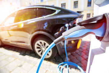 Close up of the power supply plugged into an electric car being charged