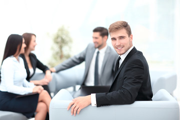successful business man at the office on the background of business team