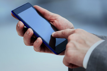 Close up of women's hands holding cell telephone with blank copy space scree for your advertising text message or promotional content, hipster girl watching video on mobile phone during coffee break