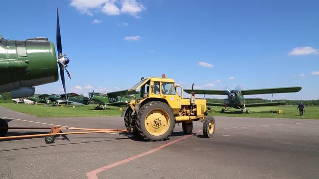 The tractor is taking the plane to the parking lot.