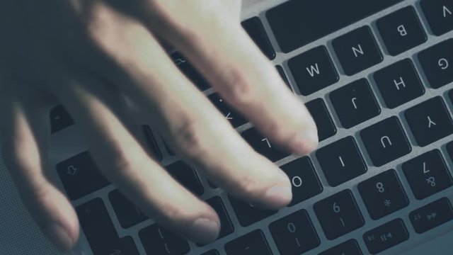 Top view of Close up macro shot.hand typing on keyboard laptop computer in 4K (UHD)
