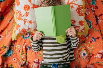 child comfortably reading a book