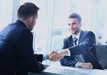 businessman shaking hands to seal a deal with his partner