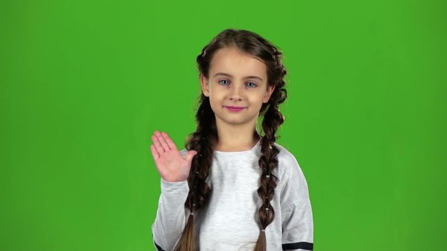 Child waves his hand. Green screen. Slow motion