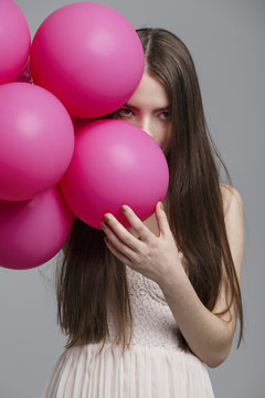 Girl with pink balloons