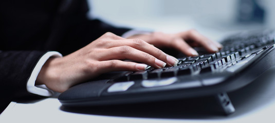 Naklejka na ściany i meble Female hands typing on computer keyboard