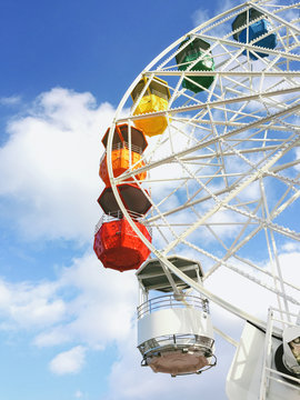 Colourful cabins on a ferris wheel on an amusement park.