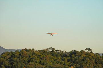 Fototapeta na wymiar small planes in cue for landing over tropical forest