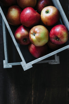 Crate of apples on dark background. Seen from above.