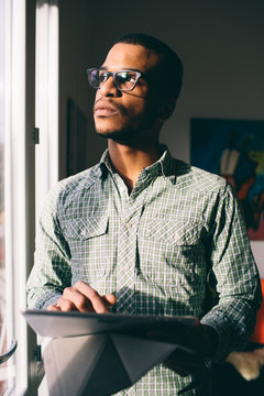 Young man holding his digital tablet
