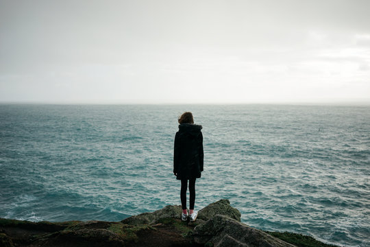 Girl standing at Land's End, Cornwall