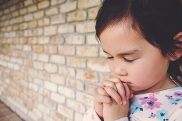 little multiethnic girl praying, kid, child pray concept,shallow DOF