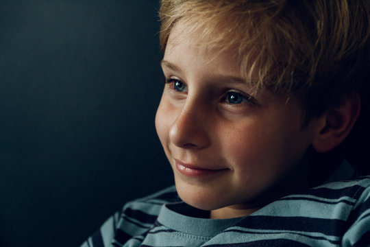 Portrait of a smily content beautiful blond young boy