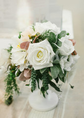 Wedding Table Centerpieces. White floral composition in a white vase.