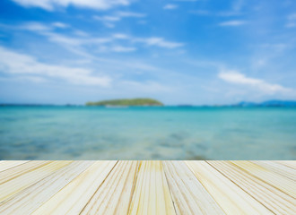 Wood table top on blurred beach background, summer concept - can be used for display or montage your products