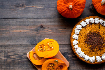 Pumpkin pie for thanksgiving day on dark wooden background top view copyspace